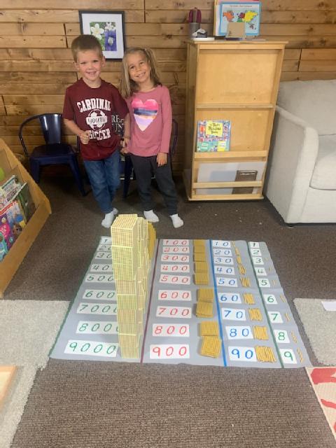 boy and girl standing by montessori beads